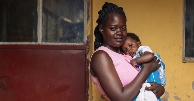 A portrait of Sharon Nakayenga, 20 with her son Abdu Malik Kayenje, 3 months, outside their home in Kazo Angolla Corner Zone are Kawempe Division, Kampala.